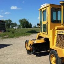 An asphalt sweeper.