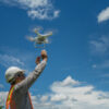 man releasing drone for construction data
