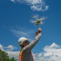 man releasing drone for construction data