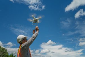 man releasing drone for construction data