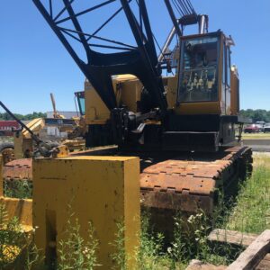 A large industrial crane in a field.