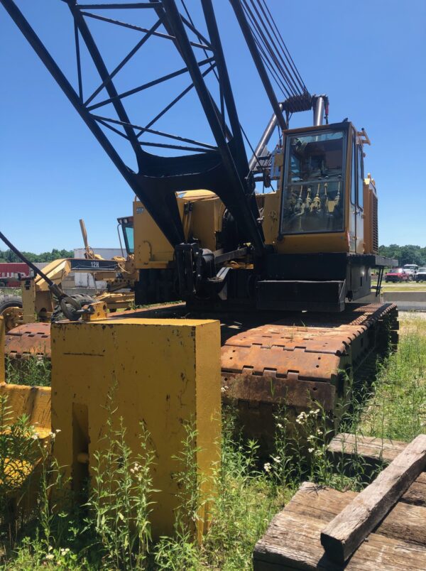 A large industrial crane in a field.