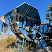 A rock crusher in a field.