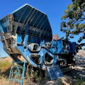 A rock crusher in a field.