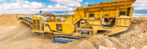 Heavy and mobile machinery in a quarry to transform stone into construction material
