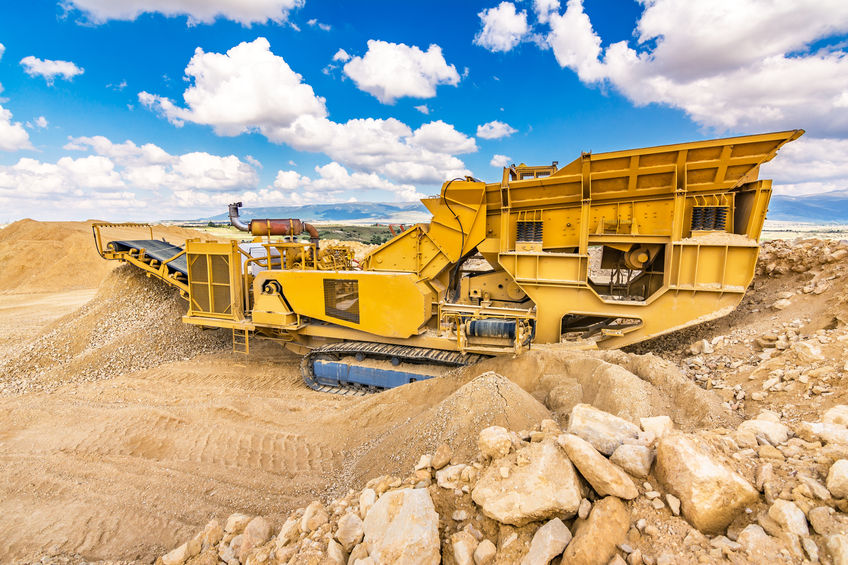 Heavy and mobile machinery in a quarry to transform stone into construction material