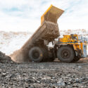 Large quarry dump truck. Loading the rock in the dumper. Loading coal into body work truck. Mining truck mining machinery, to transport coal from open-pit as the Coal. Production useful minerals.