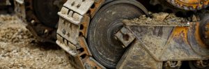 big crawler wheel, The Crawler close up , muddy crawler chain detail in earthy ambiance, Well used excavator tracks closeup
